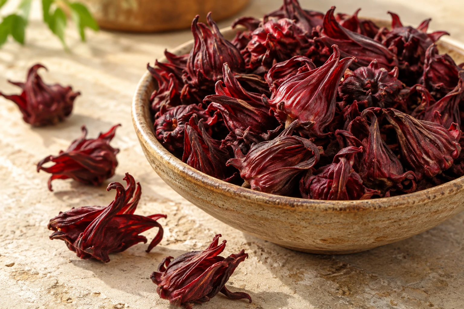 Dried red roselle calyces in a ceramic bowl